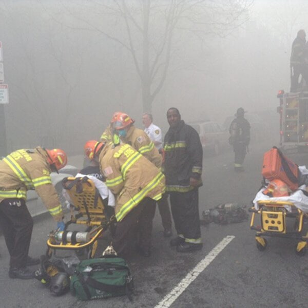 Image: Firefighters attend to an injured firefighter at the scene of a nine-alarm fire in Boston, March 26.