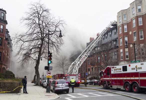 Image: Firefighters fight a multi-alarm fire at a four-story brownstone in the Back Bay neighborhood near the Charles River