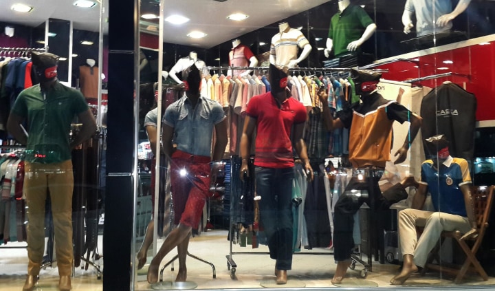 Image: Mannequins with their faces covered are displayed in a shop window in central Mosul
