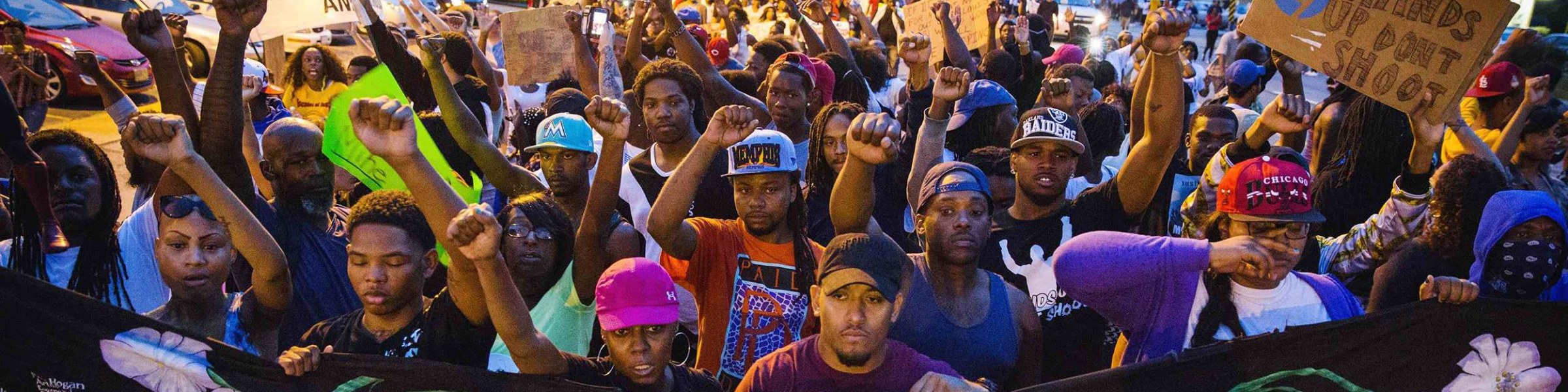 Image: Protestors march and hold their fists aloft as they march during ongoing demonstrations in reaction to the shooting of Michael Brown in Ferguson, Missouri