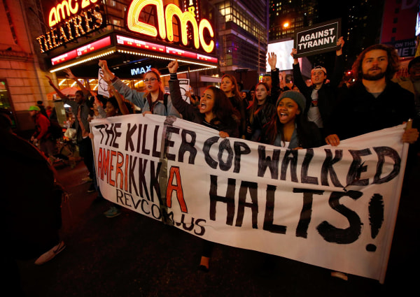 Image: People protest against the verdict announced in the shooting death of Michael Brown, in Times Square, New York