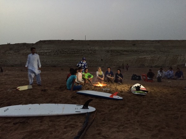 Image: Members of Iran's unnamed surfing club sit around a fire