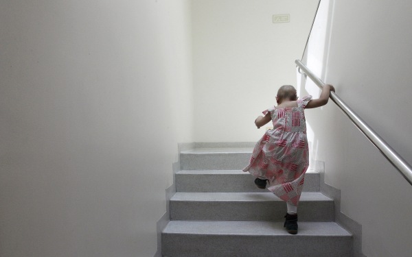 Image: Alexandra Munoz climbs stairs in the cancer ward of the Luis Calvo Mackenna Hospital in Santiago