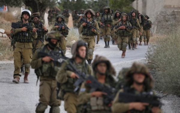 Image: Israeli soldiers patrol on the West Bank village of Arura 