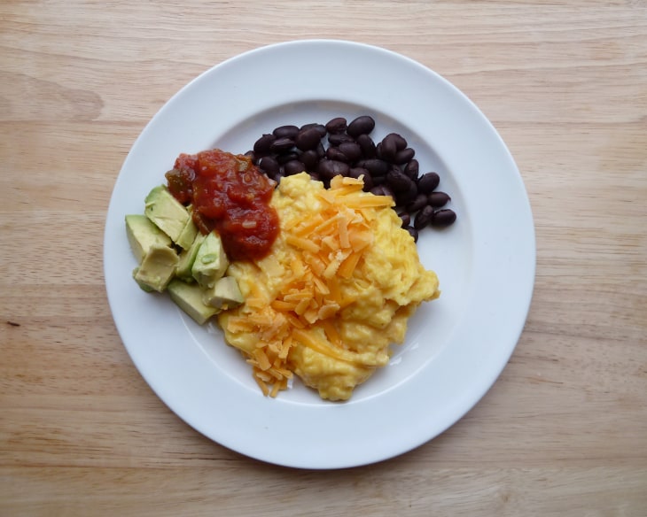 Scrambled eggs with black beans, cheese, salsa and avocado