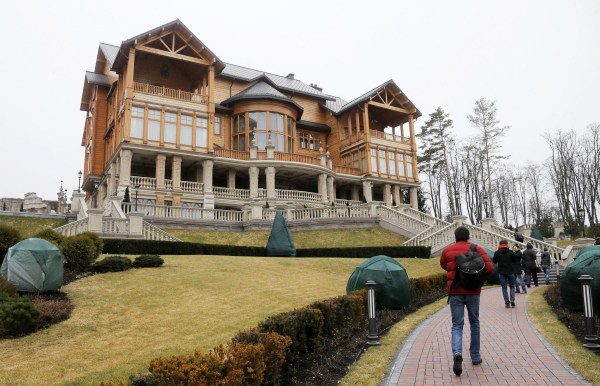 Image: People walk on the territory of Ukrainian President Yanukovych's countryside-residence