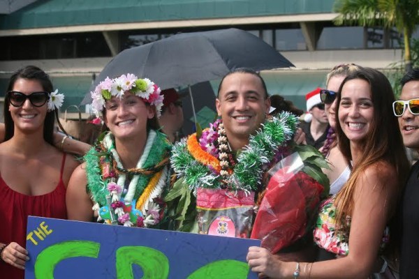 Kalā Kaawa -- covered in lei from friends, family, and complete strangers -- poses with friends after the University of Hawaii graduation ceremony.
