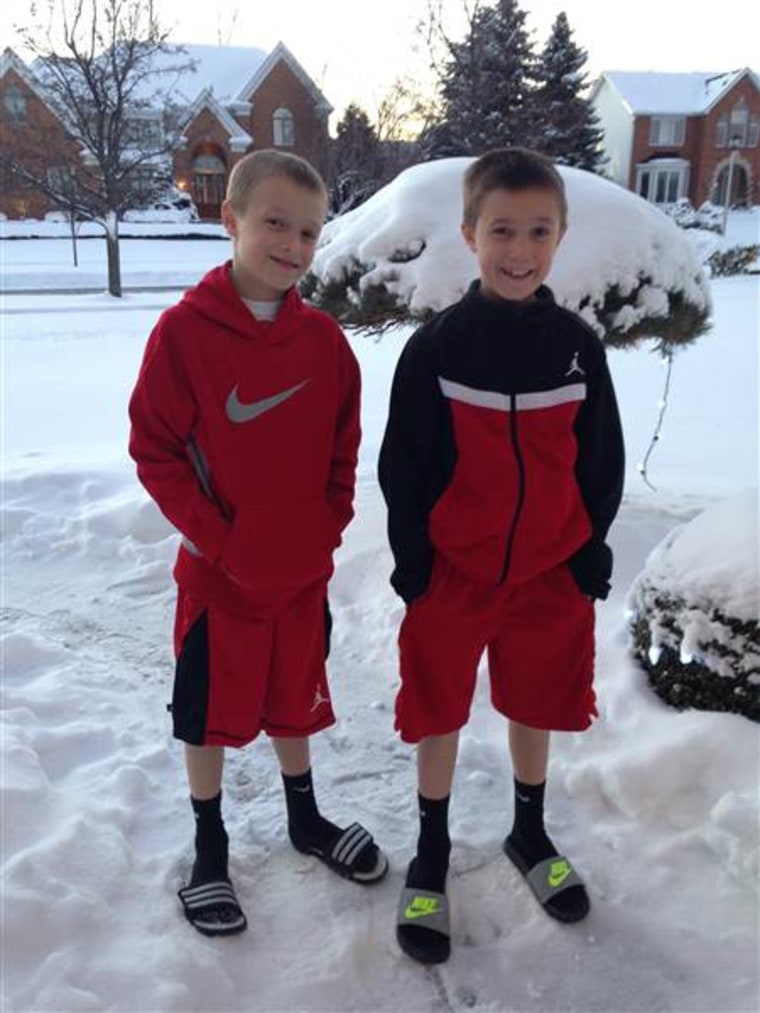 Eight-year-old twins Cameron, left, and Colin Corcoran show off their winter look in snowy Buffalo.