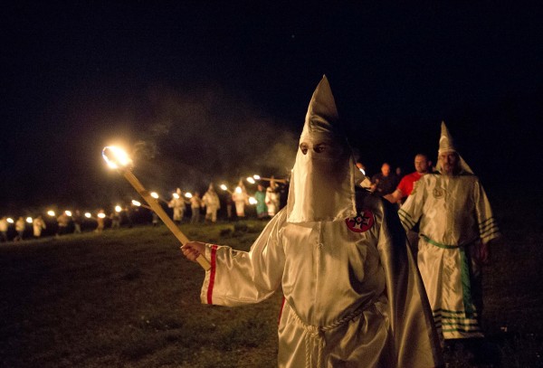Image: Members of the Ku Klux Klan participate in cross burnings after a "white pride" rally in rural Paulding County