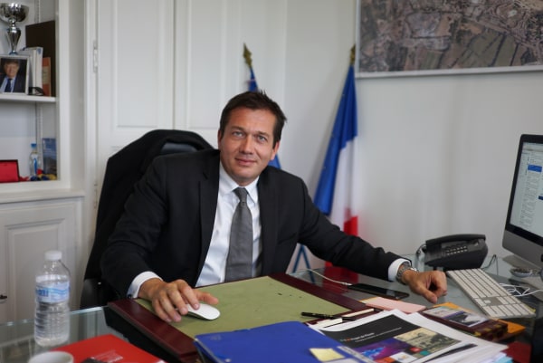 Image: Mayor Marc Etienne Lansade sits at his desk