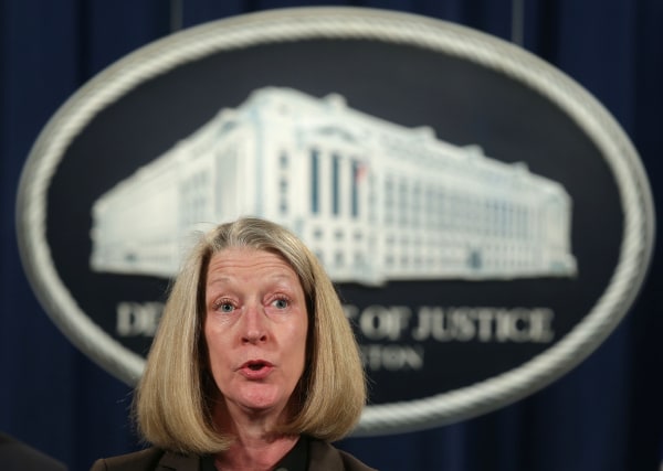 Image: Mary McCord speaks during a news conference at the Justice Department