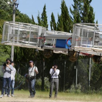Journalists film Cartivator's flying car during its demonstration in Toyota