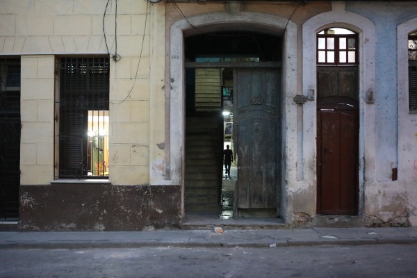 Image: A man walks into his residence during the evening hours in Matanzas, Cuba