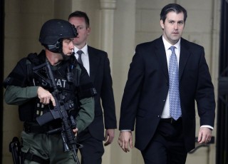 Image: Michael Slager walks from the Charleston County Courthouse under the protection from the Charleston County Sheriff's Department