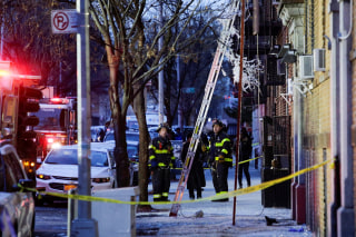 Image: Fire Department of New York (FDNY) personnel work on the scene of an apartment fire in Bronx, New York
