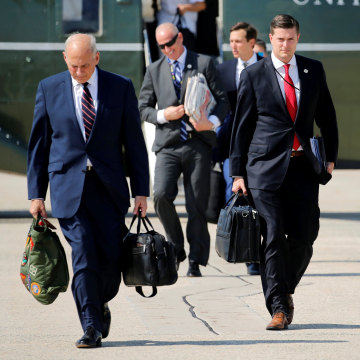 Image: Porter and Kelly walk to board Air Force One with Trump at Joint Base Andrews, Maryland
