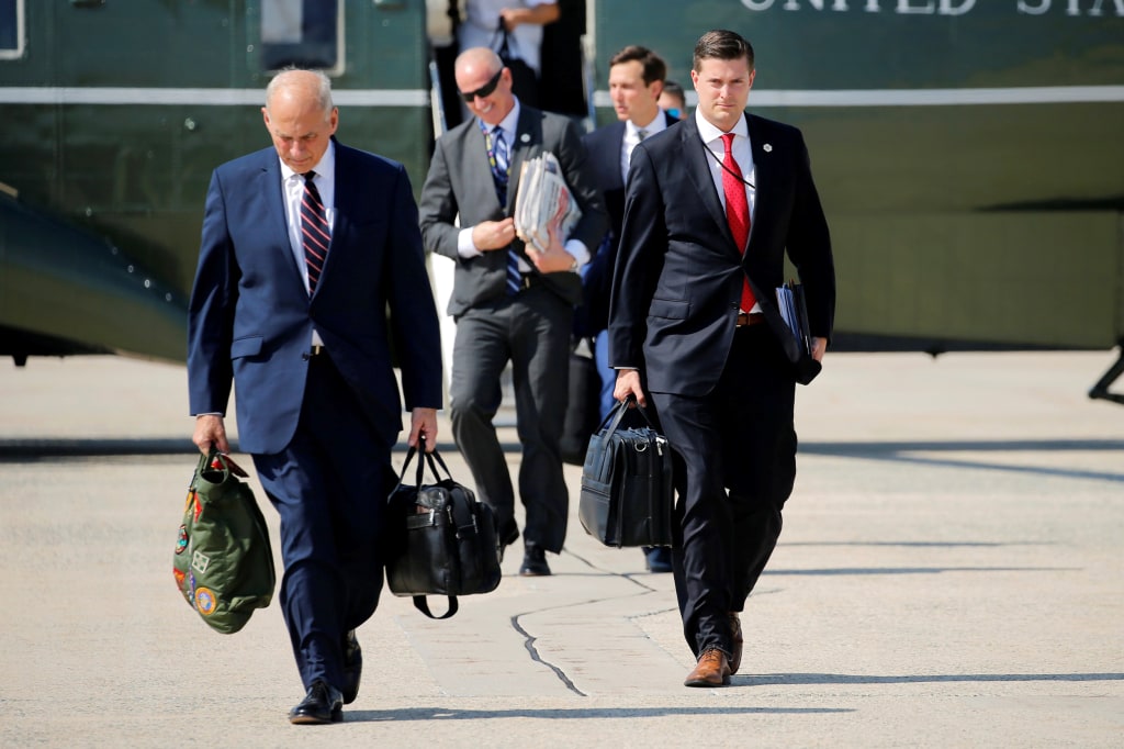 Image: Porter and Kelly walk to board Air Force One with Trump at Joint Base Andrews, Maryland