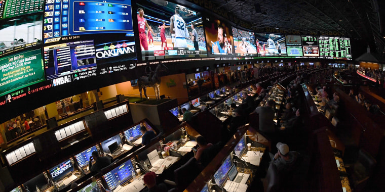 Image: Guests watch the NCAA college basketball tournament at the Westgate Superbook sports book
