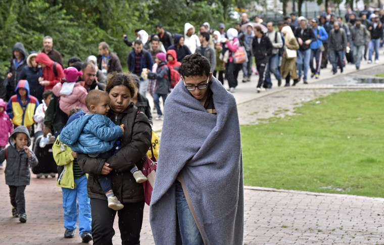 Image: Migrants walk from the main station in Dortmund, Germany