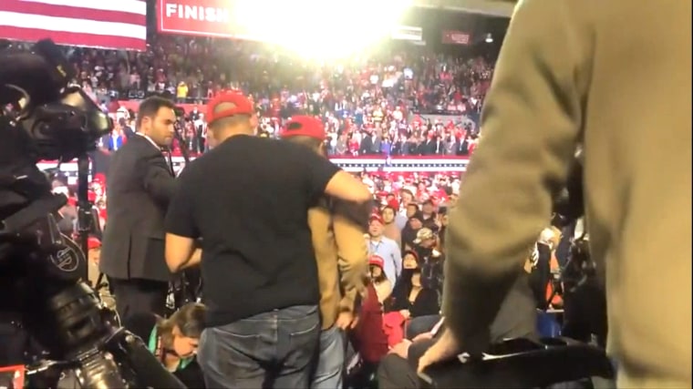 Image: A man is escorted from a Donald Trump rally in El Paso, Texas, after allegedly attacking a member of the media in attendance