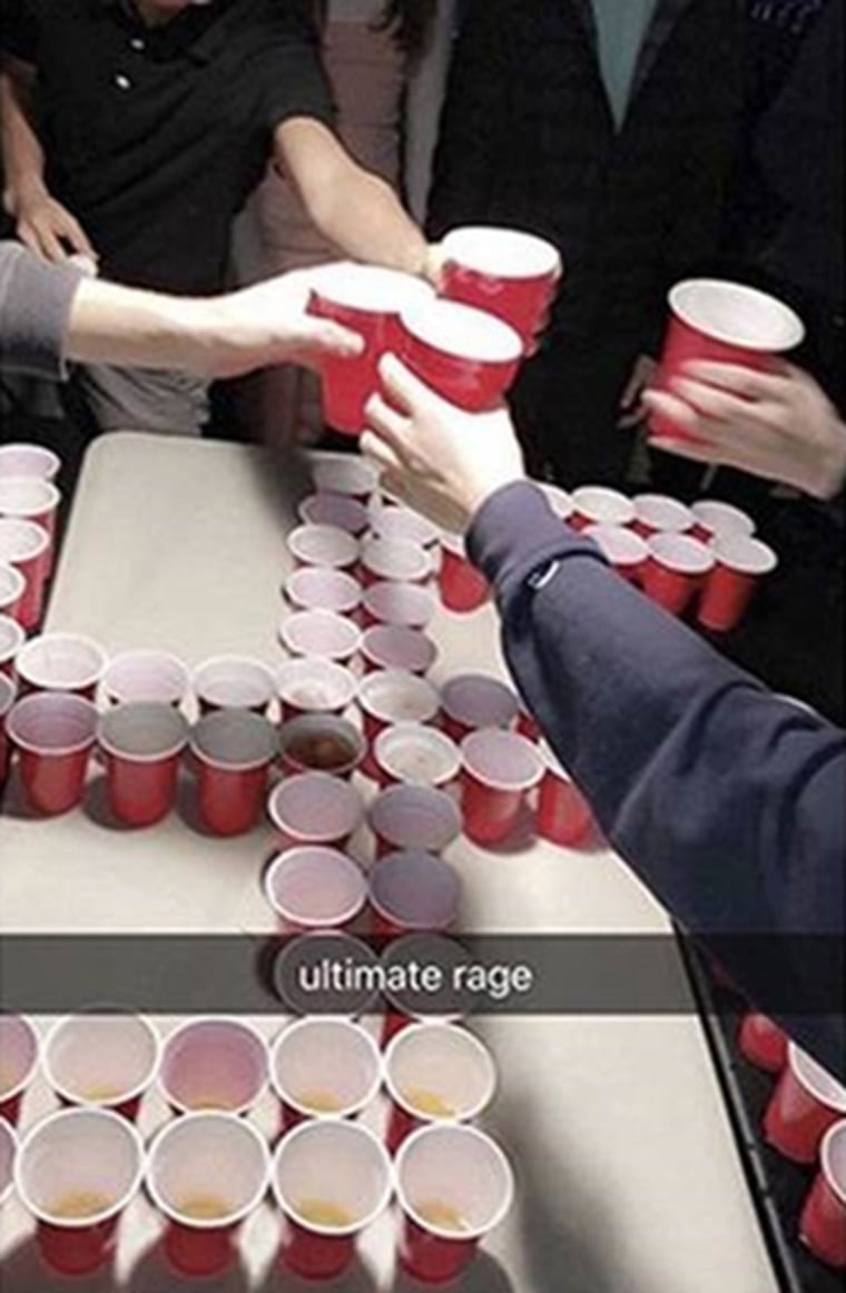  Newport-Mesa students toast over a swastika made from red plastic cups. The "ultimate rage" banner on the image was added by the social media user.
