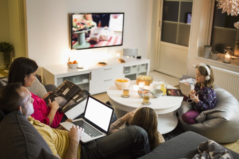 Image: Family using technologies in living room