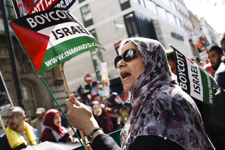 A woman holds a 'Boycott Israel' flag during the annual pro-