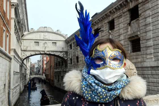 COVID-19 brings a new kind of mask to carnival in Venice (a medical face mask under the usual style of carnival mask).