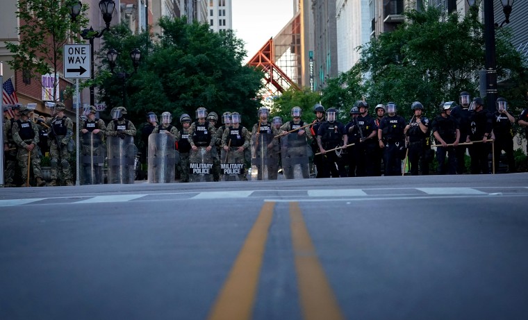 Image: The Army National Guard and Louisville Metro Police block a street during a protest in Kentucky on May 31, 2020.