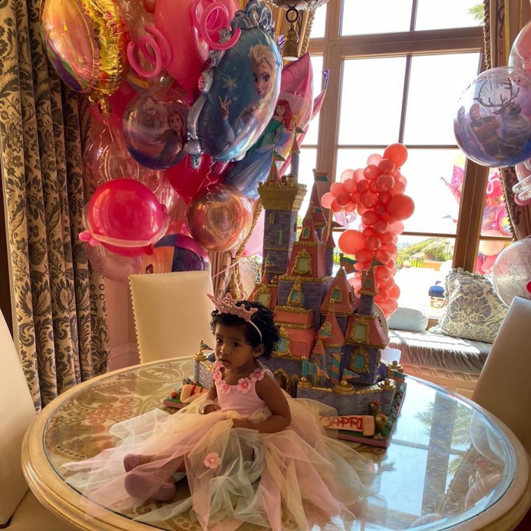 Capri Bryant sits in front of her Disney castle cake on her first birthday.