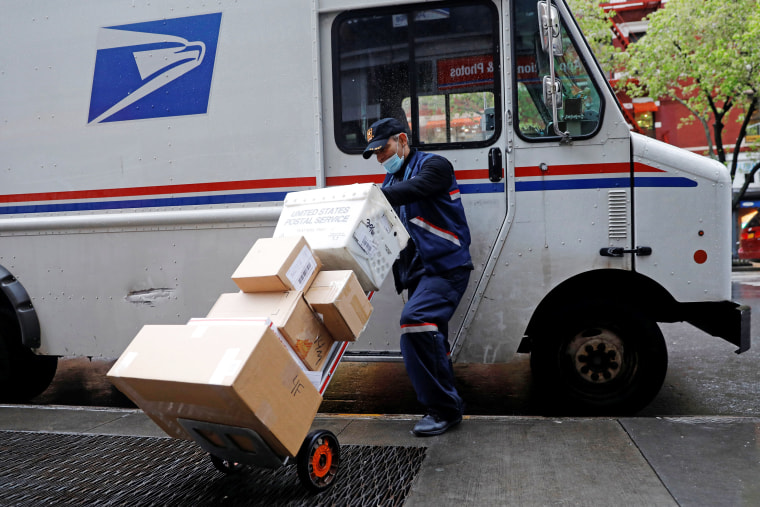 Image: United States Postal Service (USPS) worker unloads packages in Manhattan during outbreak of coronavirus disease (COVID-19) in York