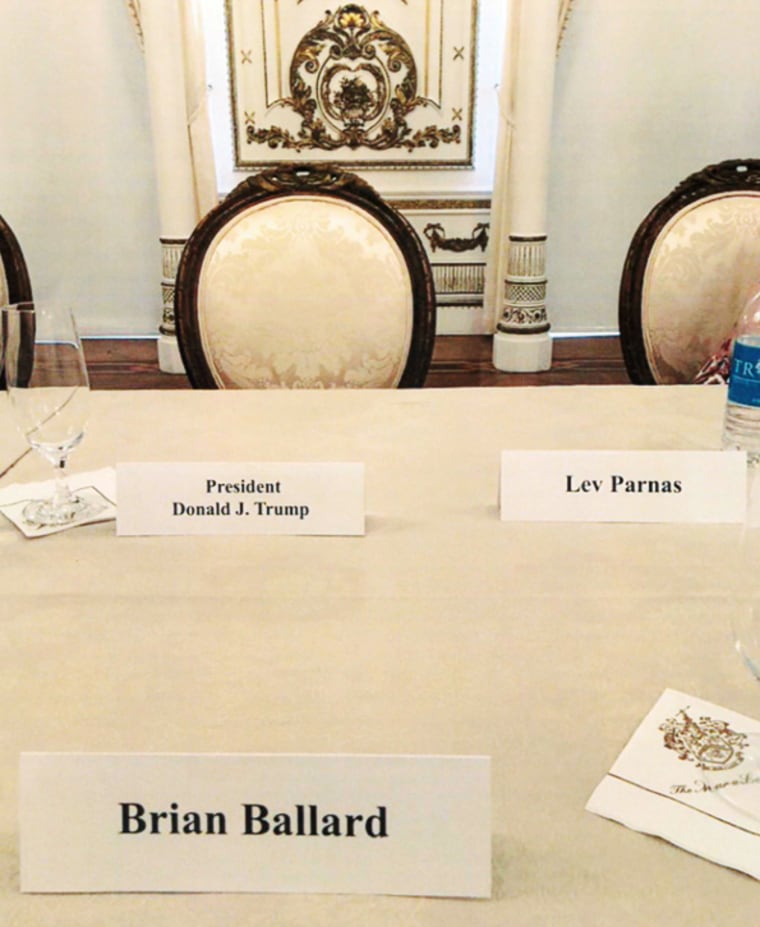 A table setting with Donald Trump, Brian Ballard and Lev Parnas seated close together for a Republican fundraising dinner at Mar-a-Lago in Palm Beach, Fla. on April 20, 2018.