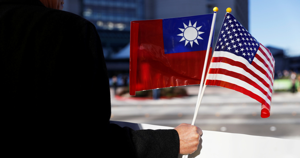 Image result for FILE PHOTO: A demonstrator holds flags of Taiwan and the United States in Burlingame, California, U.S