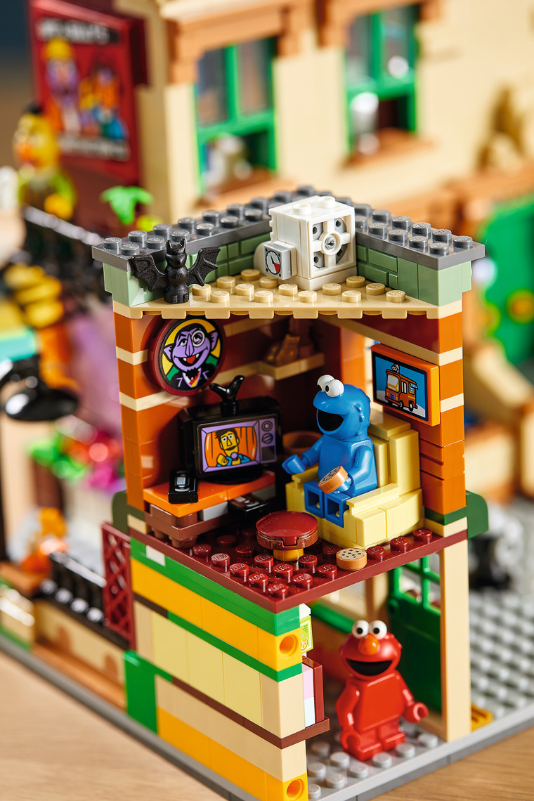 Cookie Monster watches Guy Smiley on TV in the first-ever LEGO Sesame Street set, in stores and online November 1. 