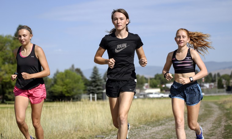 University of Montana cross country runner Juniper Eastwood, center, warming up with her teammates at Campbell Park in Missoula, Mont. on Aug. 15, 2019. 