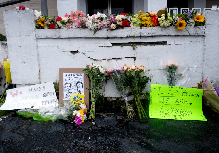Image: A memorial at Gold Spa in Atlanta, with flowers, signs and candles.