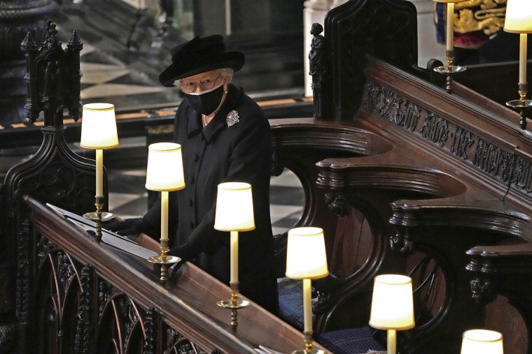 Image: Britain's Queen Elizabeth II takes her seat alone in St. George's Chapel during the funeral of Prince Philip.
