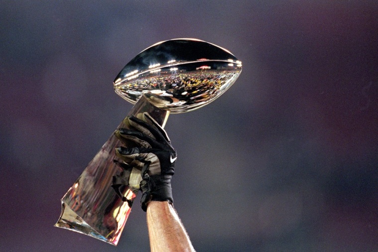 A general view of the Lombardi Trophy being held aloft before the Super Bowl XXXV Game between the New York Giants and Baltimore Ravens at the Raymond...