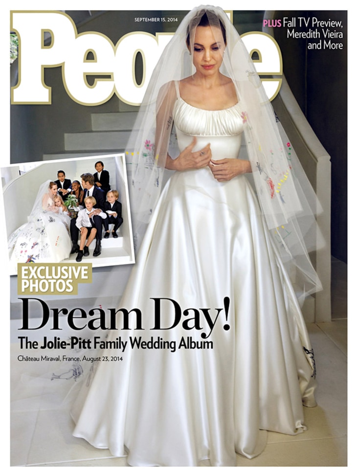 Angelina Jolie wears a classic satin gown during her Aug. 23 wedding to Brad Pitt in France. The gown, and veil, were customized with sewn-in drawings of the couple's six children.